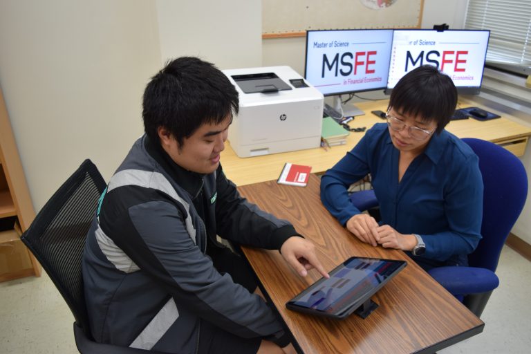 a student and advisor have a discussion in their office