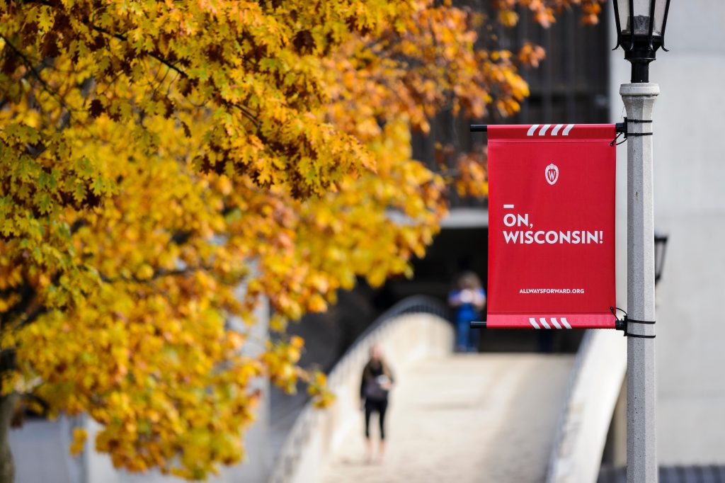 'on wisconsin' red street light banner overlooking a pedestrian bridge